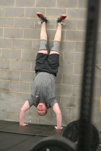 Robbie knocking out some handstand pushups during 15.4.