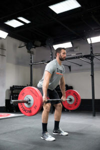 When hang cleaning, the bar cannot go below the knees.